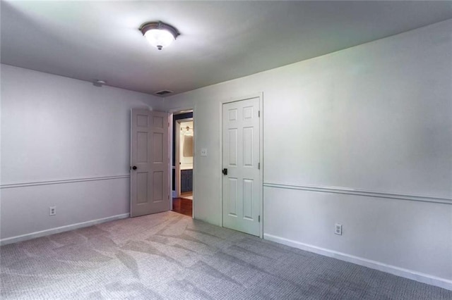 carpeted spare room with baseboards