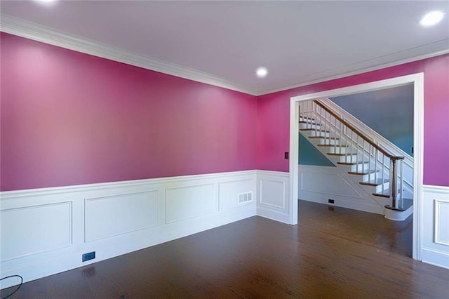 unfurnished room featuring wood finished floors, a wainscoted wall, stairs, recessed lighting, and ornamental molding
