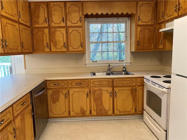 kitchen featuring white appliances, sink, and light tile patterned floors