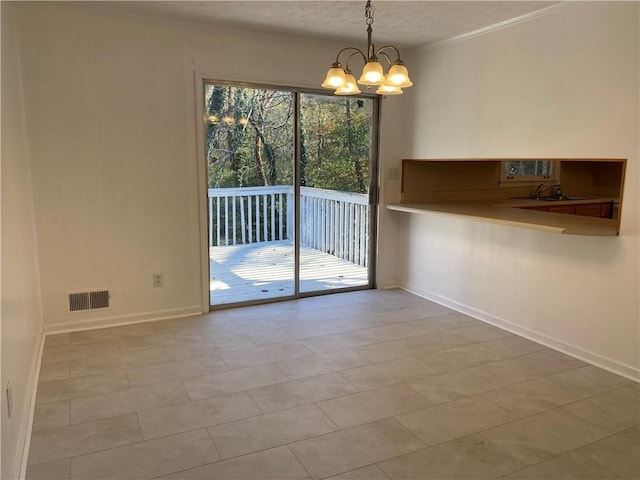 unfurnished dining area with a chandelier, light tile patterned floors, and a textured ceiling