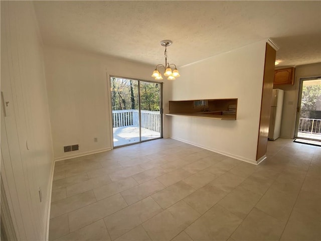 interior space with light tile patterned floors, a healthy amount of sunlight, and an inviting chandelier