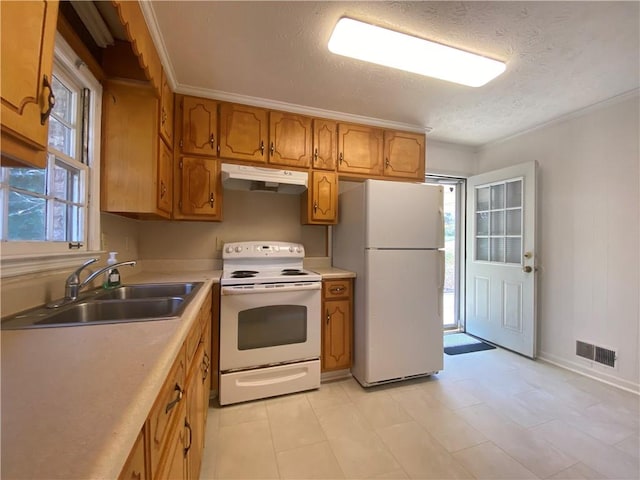 kitchen featuring a textured ceiling, sink, and white appliances