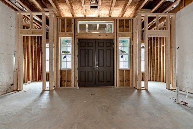 miscellaneous room featuring concrete floors and a healthy amount of sunlight