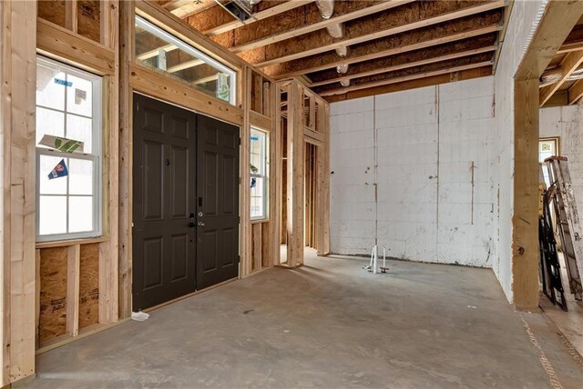 entrance foyer featuring a healthy amount of sunlight and concrete floors