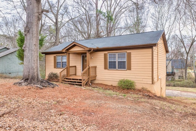 view of front of house with roof with shingles