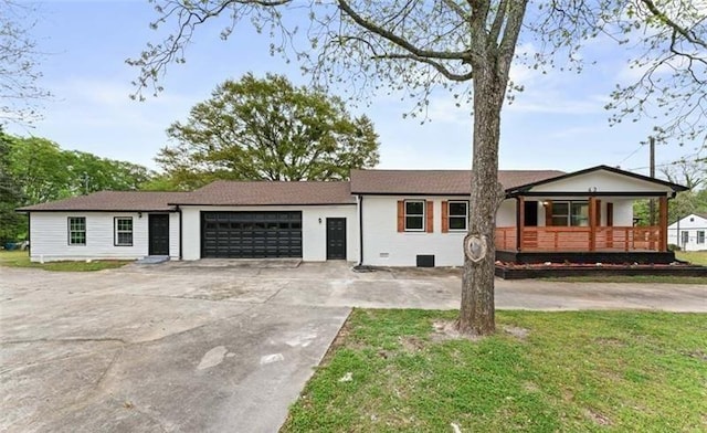 ranch-style home with a porch, concrete driveway, a front yard, crawl space, and a garage