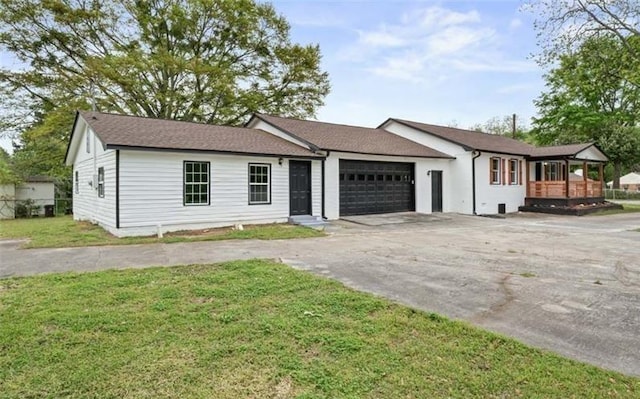 single story home with a front lawn, driveway, and an attached garage