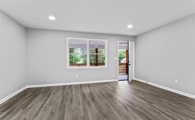 empty room featuring recessed lighting, dark wood finished floors, and baseboards