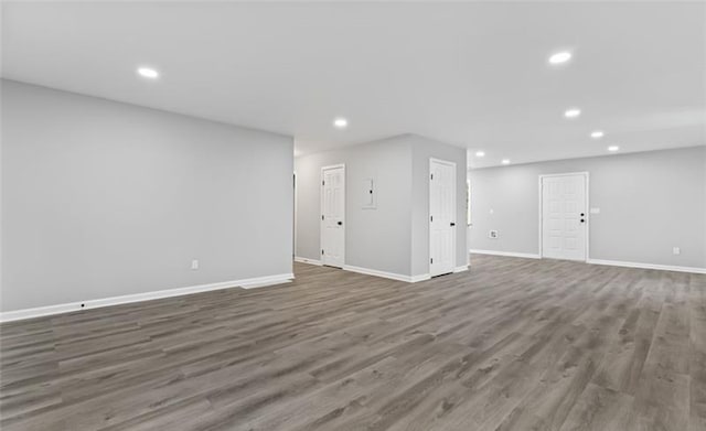 below grade area featuring baseboards, wood finished floors, and recessed lighting