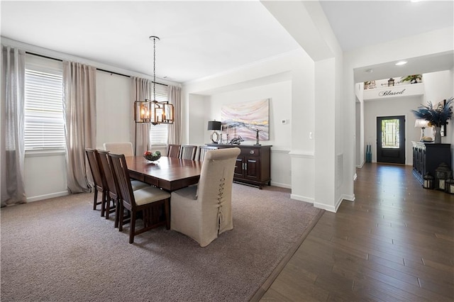 dining area featuring a notable chandelier, dark hardwood / wood-style flooring, and a wealth of natural light