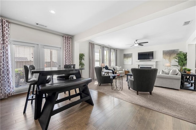 dining area featuring wood-type flooring and ceiling fan