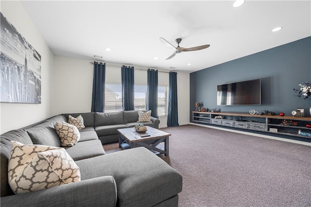 living room with ceiling fan and carpet flooring