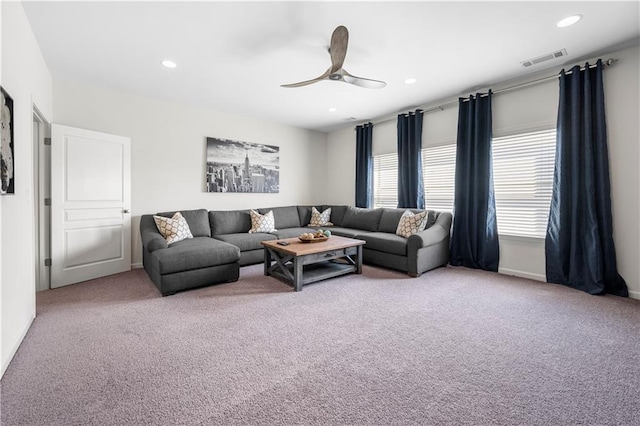 living room with ceiling fan and carpet