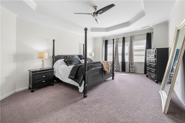 bedroom featuring carpet floors, a raised ceiling, ornamental molding, and ceiling fan