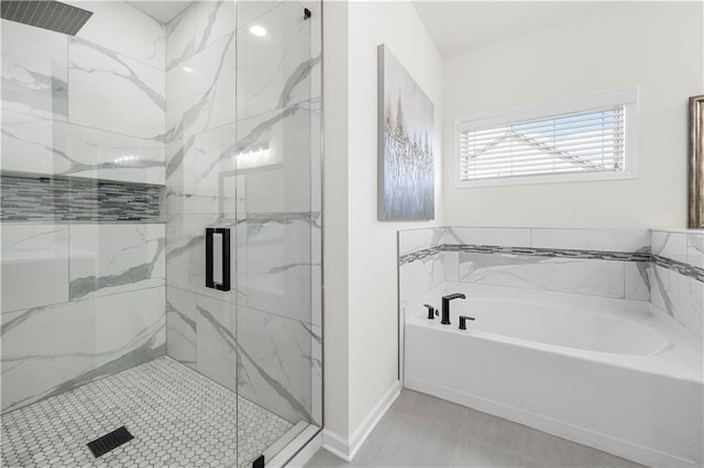 bathroom featuring shower with separate bathtub