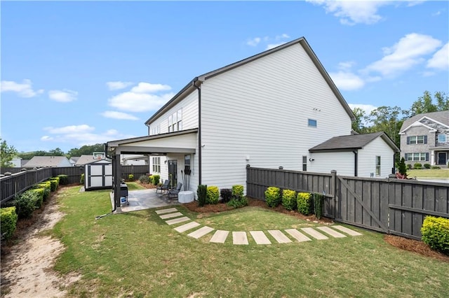 rear view of house featuring a shed, a yard, and a patio area