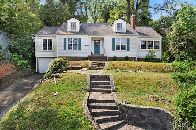 new england style home with a garage, a front lawn, driveway, and a chimney