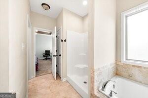 bathroom with shower with separate bathtub