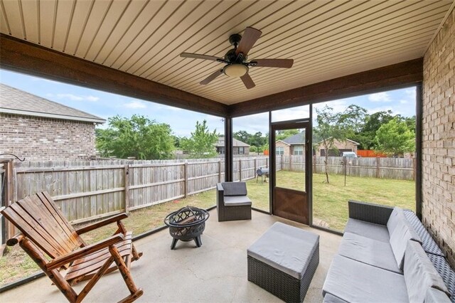 sunroom / solarium featuring wooden ceiling and ceiling fan