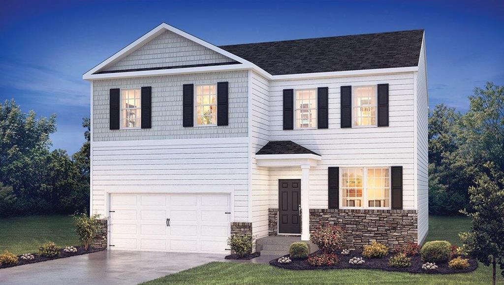 view of front of home with a front lawn and a garage