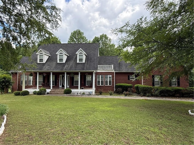 349 Bald Rock Rd, Oxford, GA 30054 - cape cod home featuring brick siding, a porch, and a front lawn