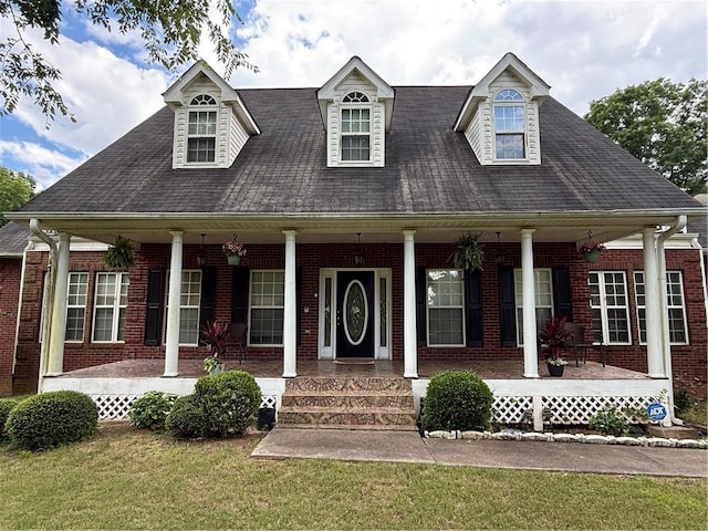 349 Bald Rock Rd, Oxford, GA 30054 - cape cod home featuring a porch, brick siding, a front yard, and a shingled roof