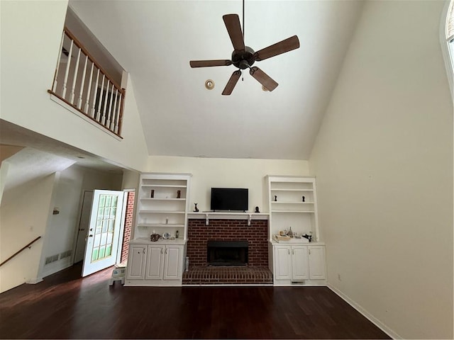 349 Bald Rock Rd, Oxford, GA 30054 - unfurnished living room with high vaulted ceiling, a brick fireplace, ceiling fan, dark wood-style flooring, and baseboards