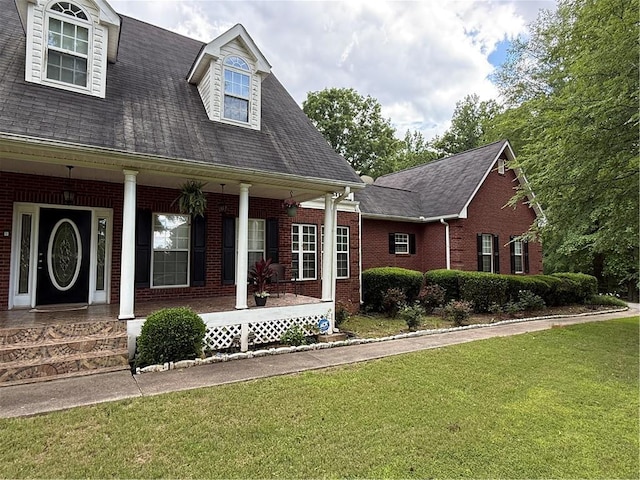 349 Bald Rock Rd, Oxford, GA 30054 - view of front of home with brick siding, a front lawn, a porch, and a shingled roof