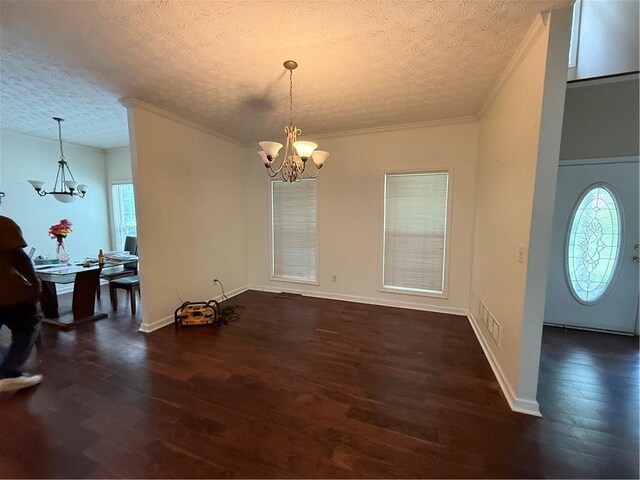 349 Bald Rock Rd, Oxford, GA 30054 - foyer entrance with a chandelier, dark wood-style floors, a textured ceiling, plenty of natural light, and ornamental molding