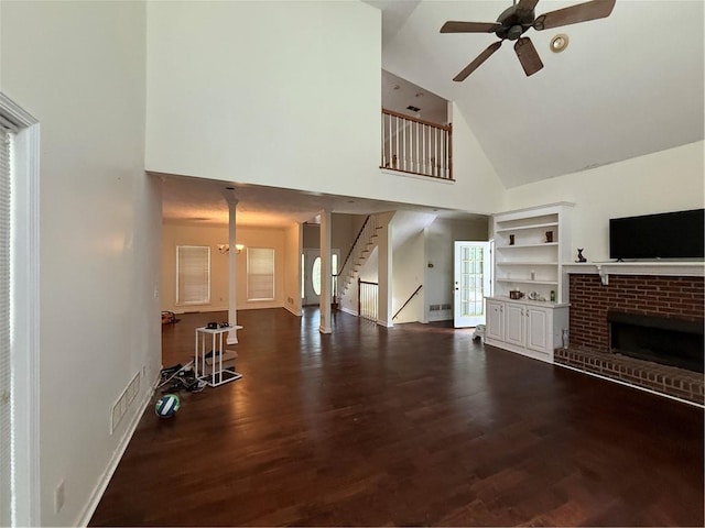 349 Bald Rock Rd, Oxford, GA 30054 - unfurnished living room with high vaulted ceiling, a ceiling fan, dark wood finished floors, stairway, and a fireplace
