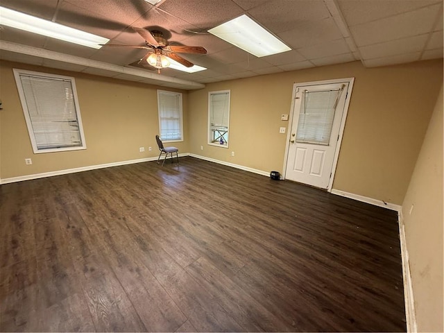 349 Bald Rock Rd, Oxford, GA 30054 - empty room with dark wood finished floors, a drop ceiling, baseboards, and a ceiling fan