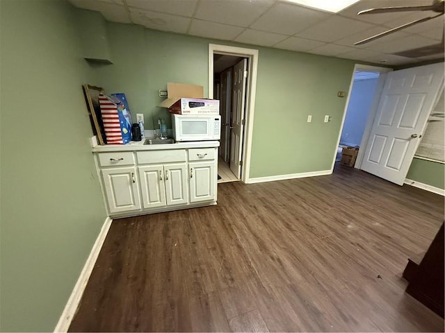 349 Bald Rock Rd, Oxford, GA 30054 - unfurnished room with baseboards, dark wood finished floors, a paneled ceiling, and a sink