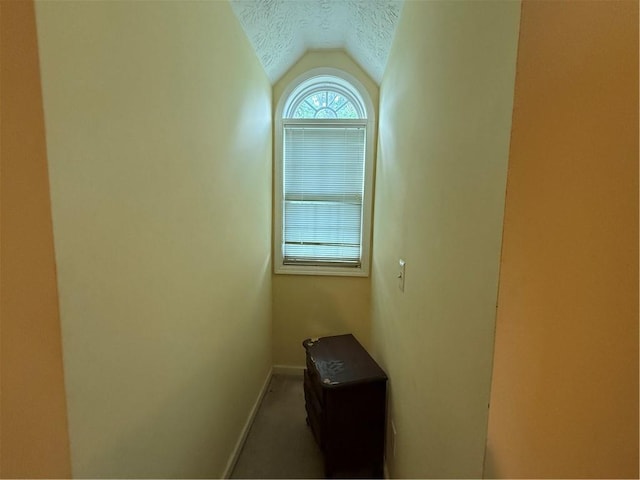 349 Bald Rock Rd, Oxford, GA 30054 - hallway with vaulted ceiling, a textured ceiling, and baseboards