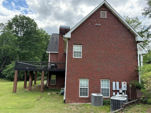349 Bald Rock Rd, Oxford, GA 30054 - view of home's exterior featuring cooling unit, brick siding, a lawn, and a chimney