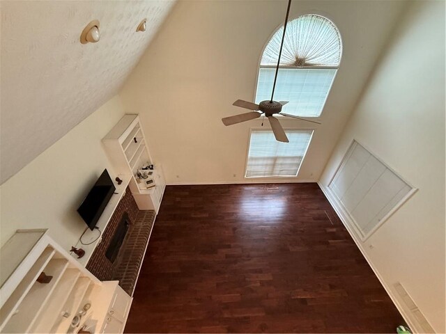349 Bald Rock Rd, Oxford, GA 30054 - unfurnished living room featuring healthy amount of natural light, wood finished floors, high vaulted ceiling, and a ceiling fan
