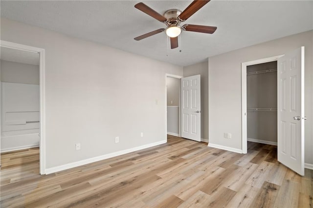 unfurnished bedroom featuring a closet, ceiling fan, and light wood-type flooring