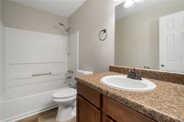 full bathroom with vanity, wood-type flooring, bathing tub / shower combination, and toilet