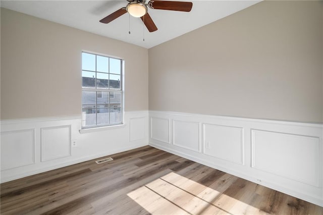 spare room with light hardwood / wood-style flooring and ceiling fan