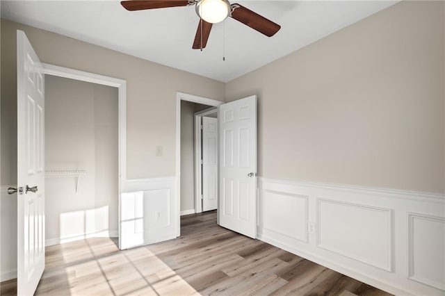 unfurnished bedroom featuring ceiling fan and light wood-type flooring