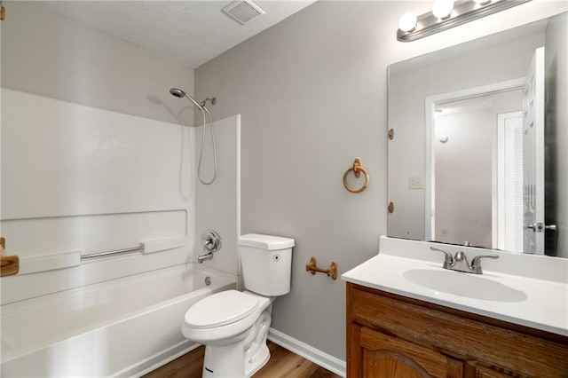 full bathroom with hardwood / wood-style flooring, vanity, shower / washtub combination, and toilet