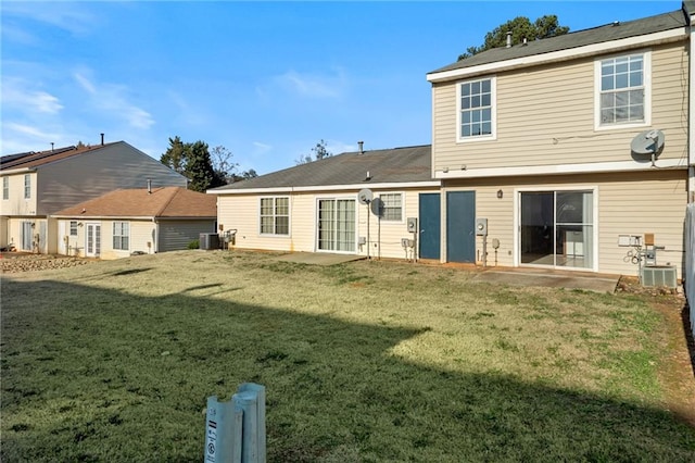 back of house featuring central AC, a yard, and a patio area