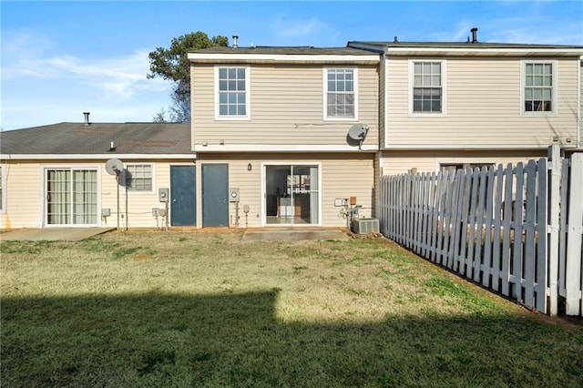 rear view of house featuring a lawn and a patio area