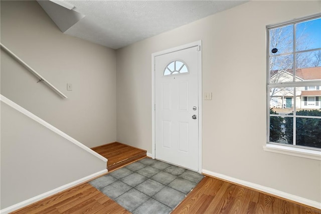 entrance foyer featuring hardwood / wood-style flooring and a textured ceiling