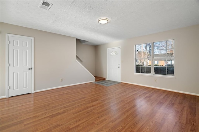 interior space featuring hardwood / wood-style flooring and a textured ceiling