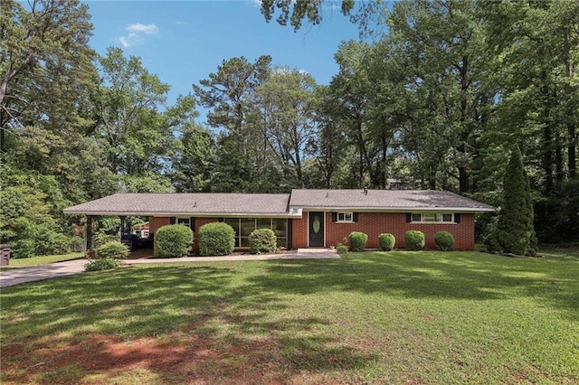 view of front of property featuring a carport, driveway, a front lawn, and brick siding