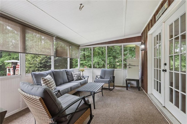 sunroom with french doors, an outdoor hangout area, and vaulted ceiling