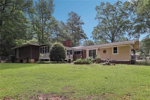rear view of house featuring a chimney