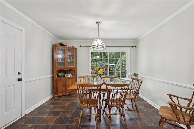 dining room with baseboards, ornamental molding, a chandelier, and dark stone finish flooring