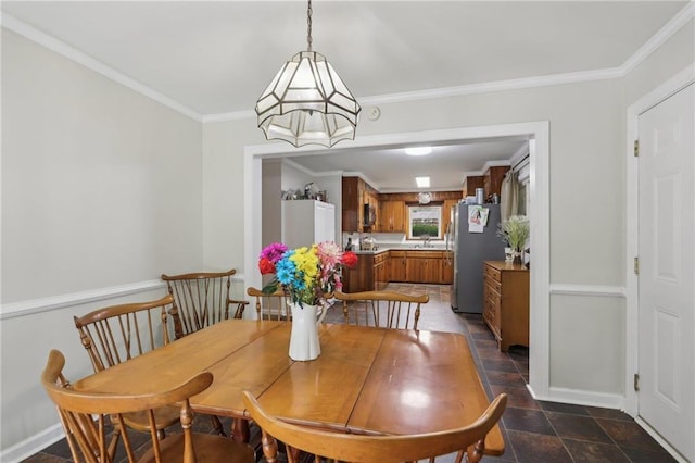 dining room with crown molding and baseboards