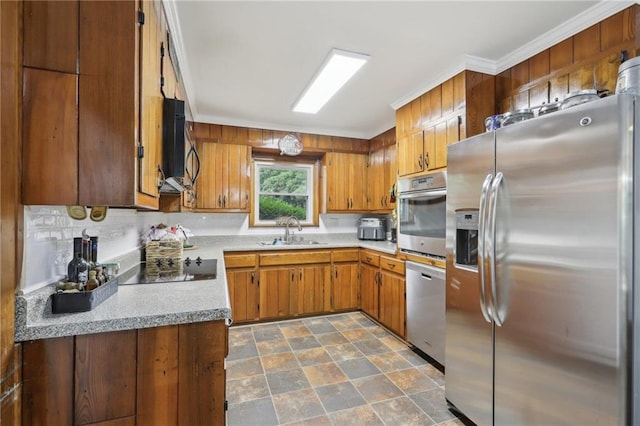 kitchen featuring appliances with stainless steel finishes, a sink, light countertops, brown cabinetry, and ornamental molding